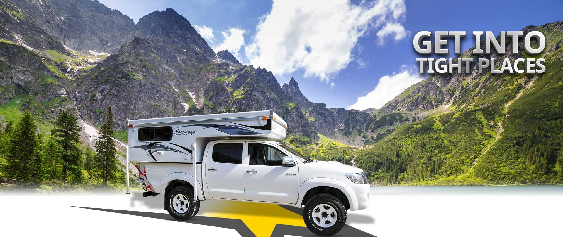 White truck with camper in front of vast mountains with Get Into Tight Places text overlayed.